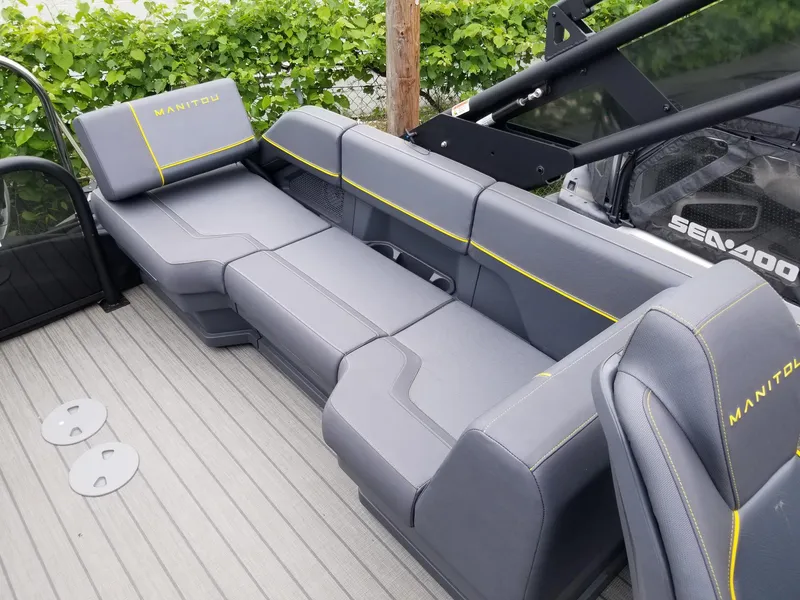 Slide: The Image of 2023 Manitou Explore Navigator 24 with Trifold Bench, SHP575, gray seating on boat deck. - 7
