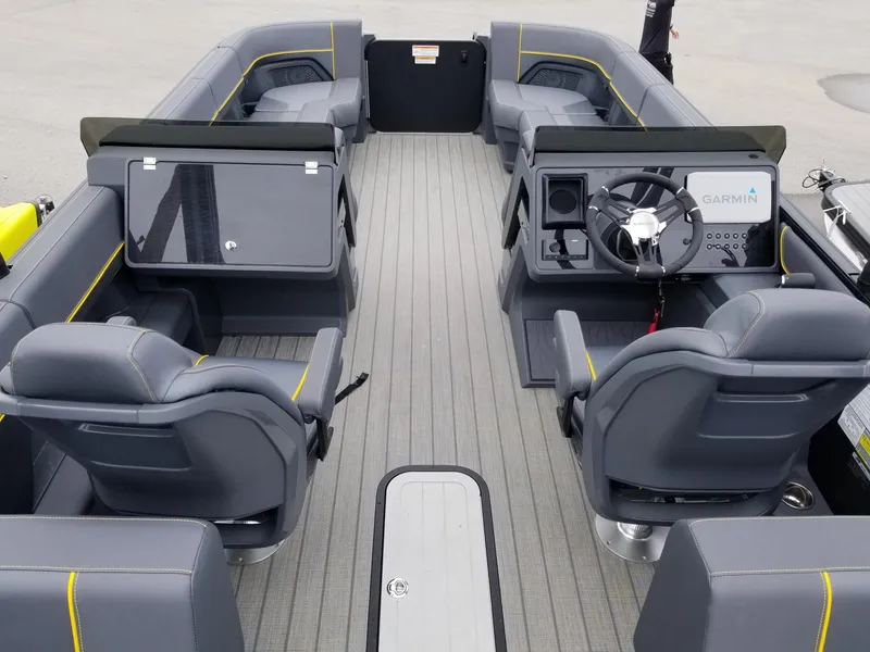 Slide: The Image of 2023 Manitou Explore Navigator 24 pontoon boat interior with trifold bench and Garmin navigation system. - 9