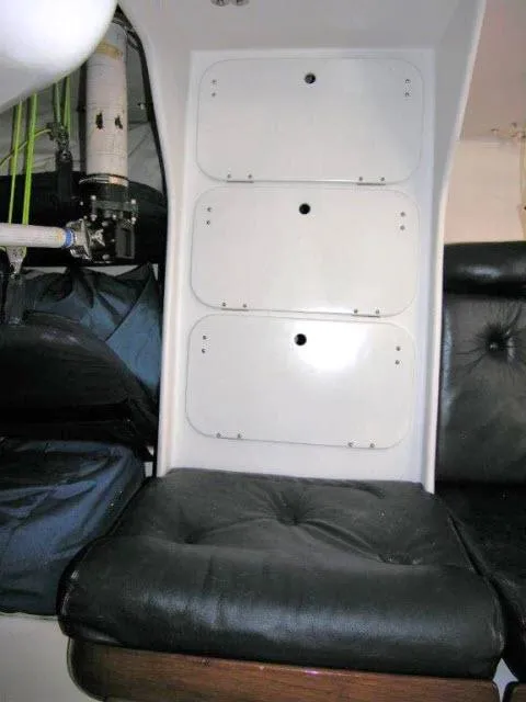 Slide: The Image of Interior of 1993 Green Marine Dubois 50 yacht with black leather seating and storage compartments. - 11