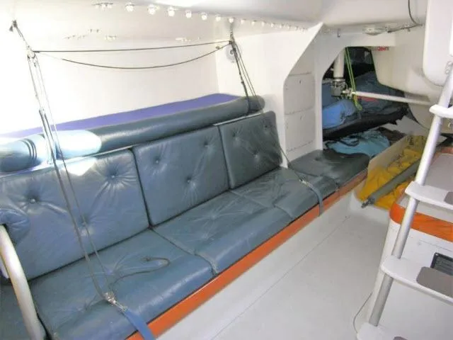 Slide: The Image of Interior of 1993 Green Marine Dubois 50 sailboat with blue cushioned seating. - 3