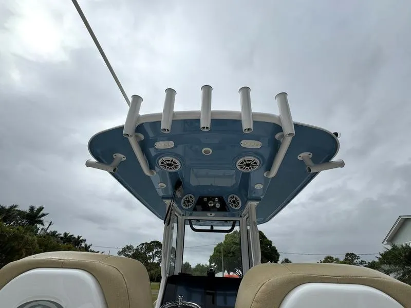 Slide: The Image of 2023 Sportsman Masters 267 Bay boat with rod holders and speakers on the T-top. - 13