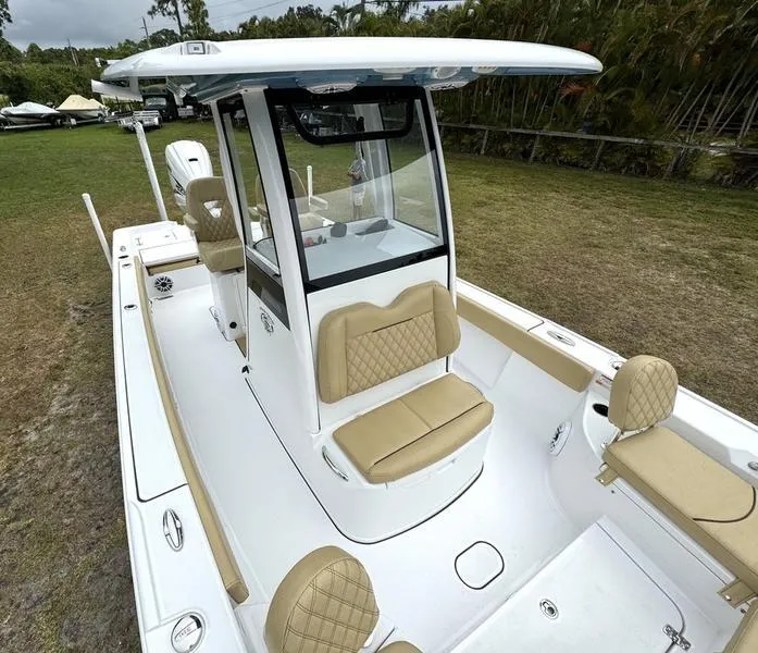 Slide: The Image of 2023 Sportsman Masters 267 Bay boat with tan seating and white deck. - 17