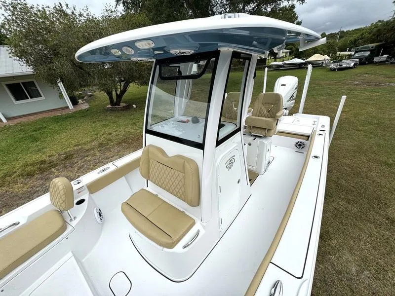 Slide: The Image of 2023 Sportsman Masters 267 Bay boat with tan seating and center console. - 18