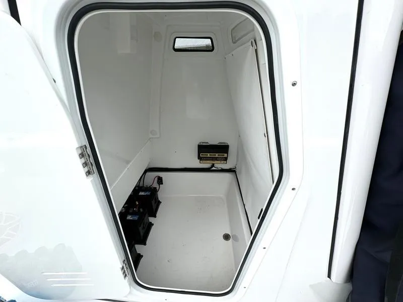 Slide: The Image of 2023 Sportsman Masters 267 Bay boat storage compartment with batteries. - 20