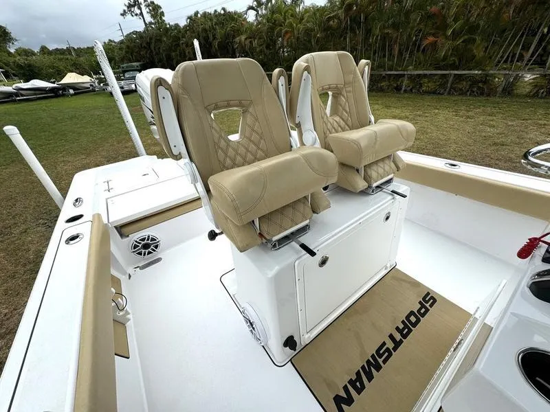 Slide: The Image of 2023 Sportsman Masters 267 Bay boat with tan seats and white deck. - 23