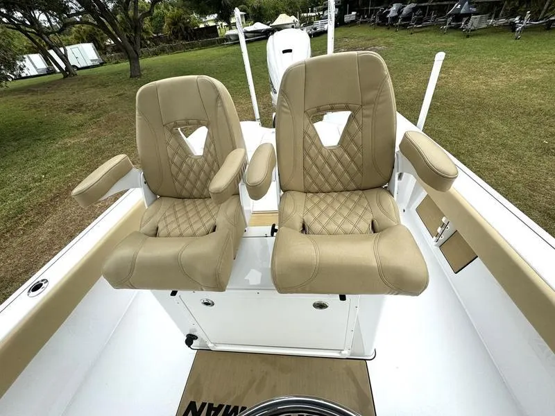 Slide: The Image of 2023 Sportsman Masters 267 Bay boat with dual tan captain's chairs. - 25