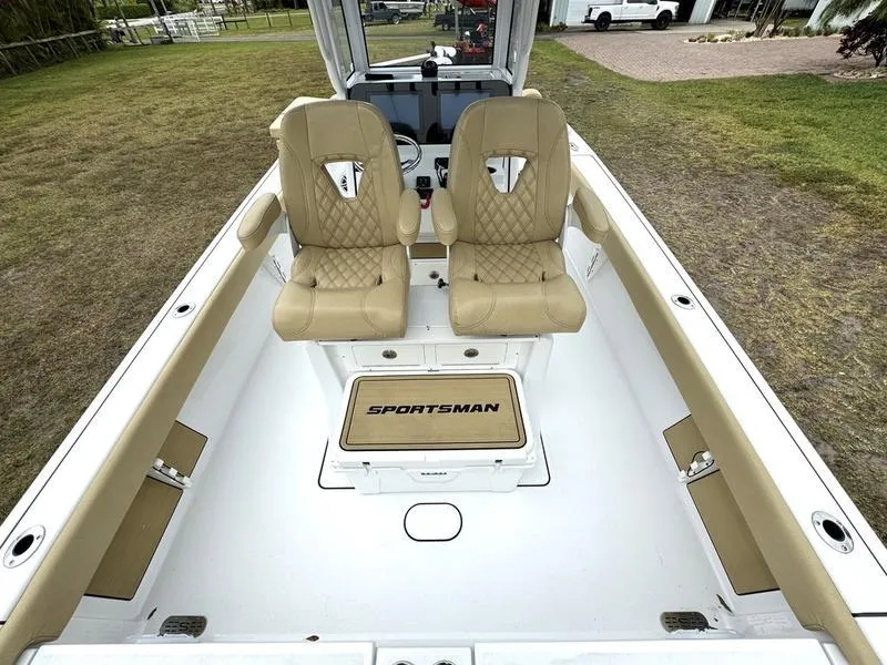 Slide: The Image of 2023 Sportsman Masters 267 Bay boat interior with tan seats and white deck. - 27