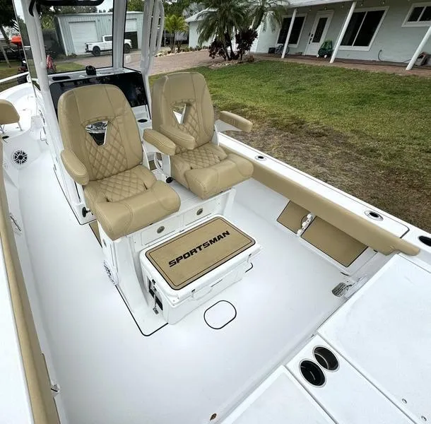 Slide: The Image of 2023 Sportsman Masters 267 Bay boat interior with tan seats and white deck. - 28