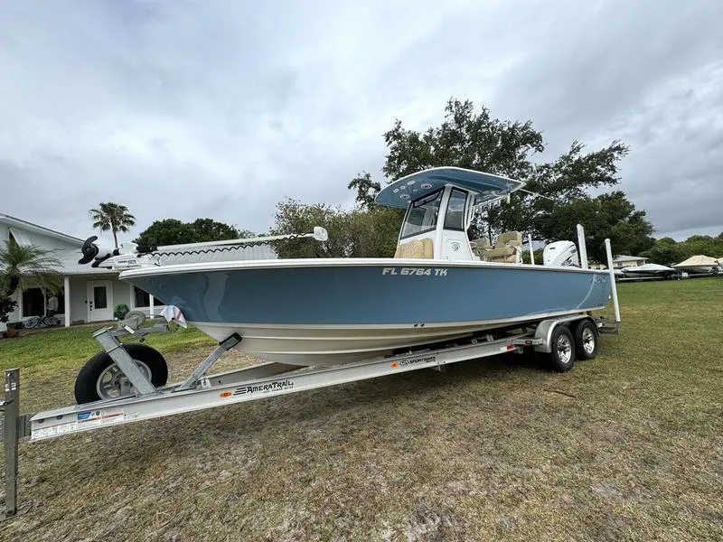 Slide: The Image of 2023 Sportsman Masters 267 Bay boat on trailer in grassy yard. - 3
