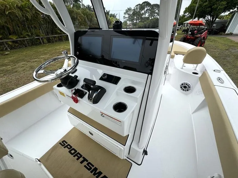Slide: The Image of 2023 Sportsman Masters 267 Bay boat console with dual screens and steering wheel. - 30