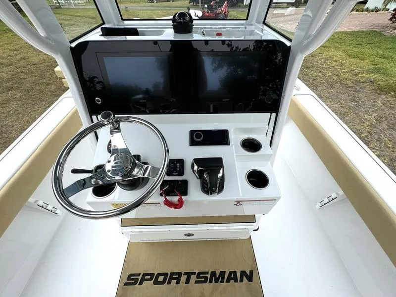 Slide: The Image of 2023 Sportsman Masters 267 Bay boat dashboard with steering wheel and control panel. - 31
