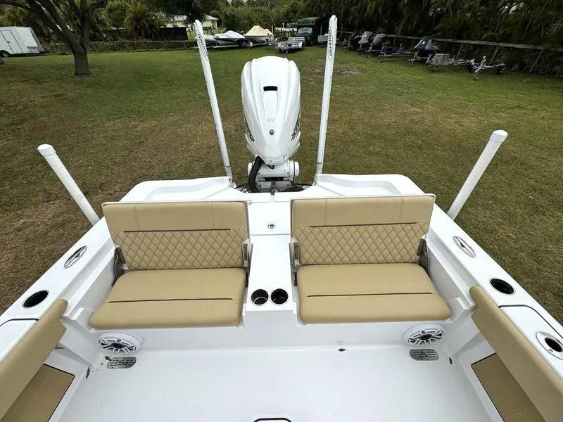 Slide: The Image of 2023 Sportsman Masters 267 Bay boat with beige seating and white motor. - 33