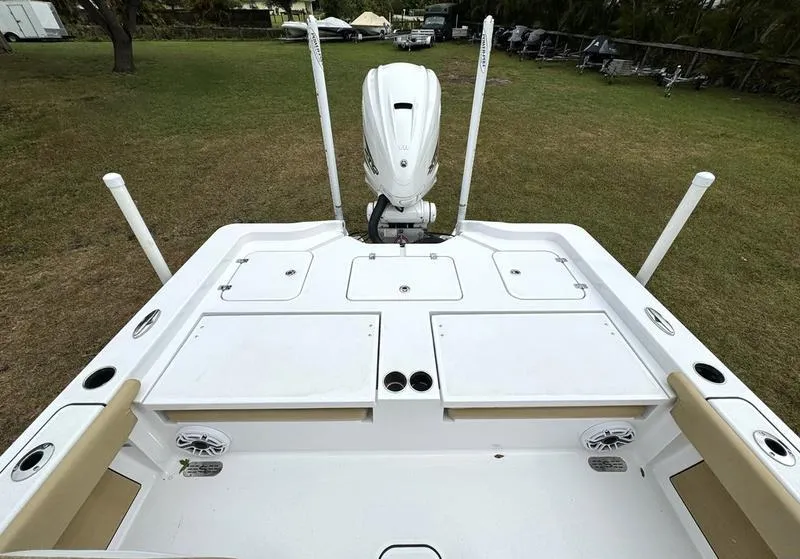 Slide: The Image of 2023 Sportsman Masters 267 Bay boat, rear deck view with storage compartments and outboard motor. - 35