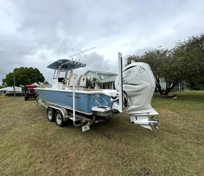 Slide: The Image of 2023 Sportsman Masters 267 Bay boat on a trailer in a grassy yard. - 5