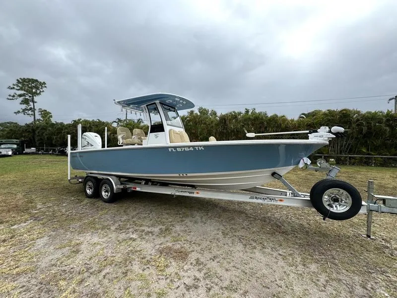 Slide: The Image of 2023 Sportsman Masters 267 Bay boat on a trailer in a grassy area. - 7