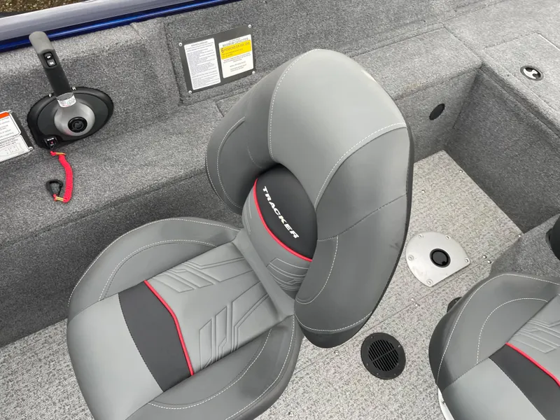 Slide: The Image of 2023 Tracker Pro Guide V-175 WT boat interior with gray seats and control panel. - 6