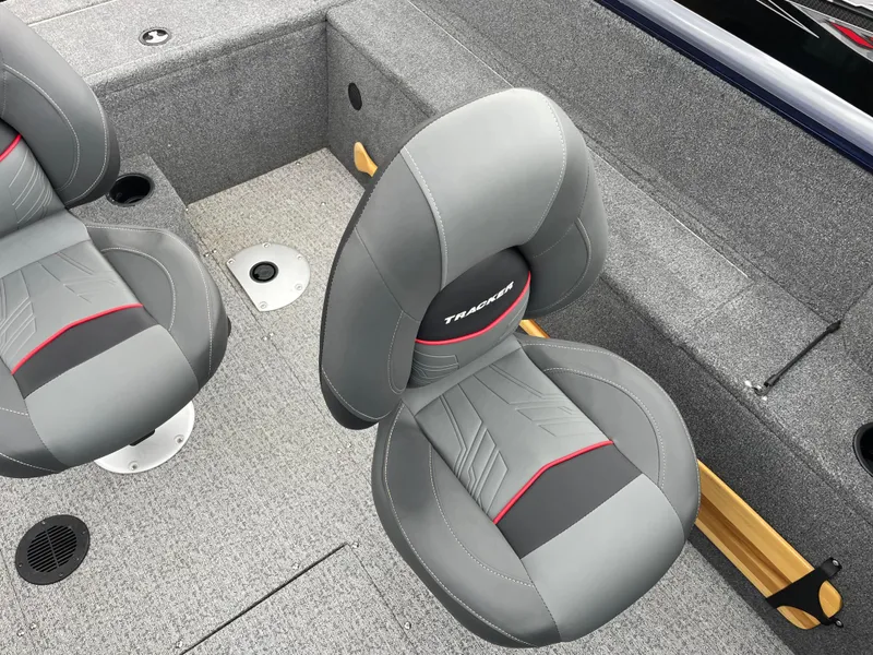 Slide: The Image of 2023 Tracker Pro Guide V-175 WT boat interior with gray and red seats. - 8