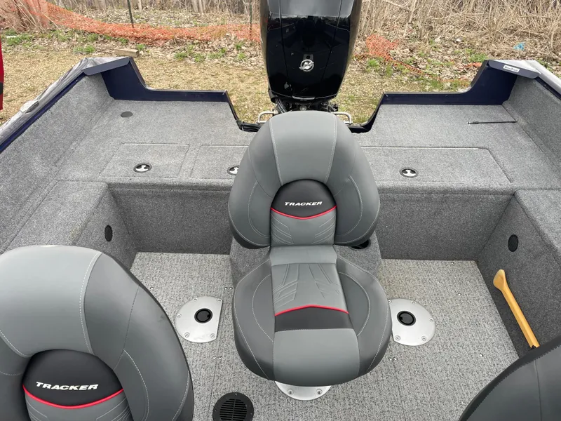 Slide: The Image of 2023 Tracker Pro Guide V-175 WT boat interior with gray seats and motor. - 9