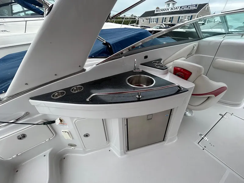 Slide: The Image of 2009 Crownline 300 LS boat interior with sink and seating. - 13