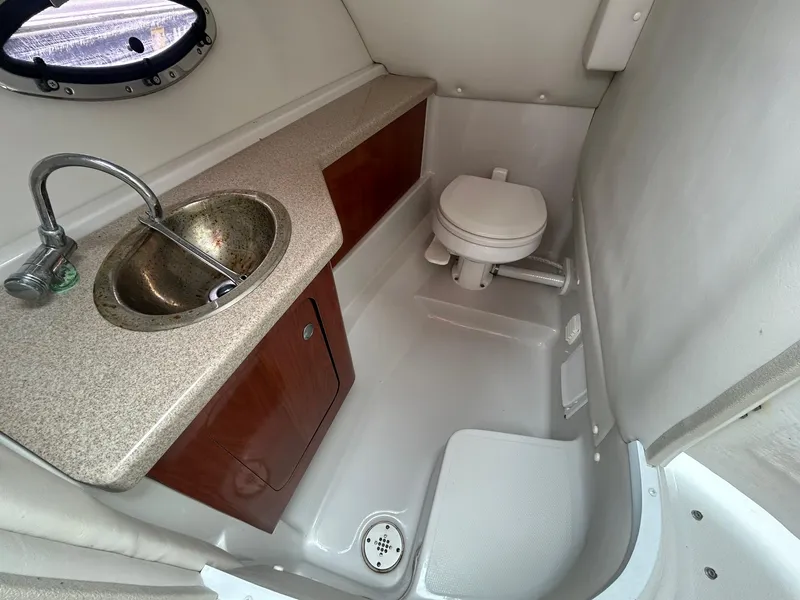 Slide: The Image of 2009 Crownline 300 LS boat bathroom with sink and toilet. - 14