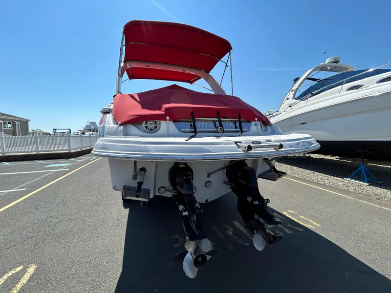 Slide: The Image of 2009 Crownline 300 LS boat with red canopy and twin propellers. - 4