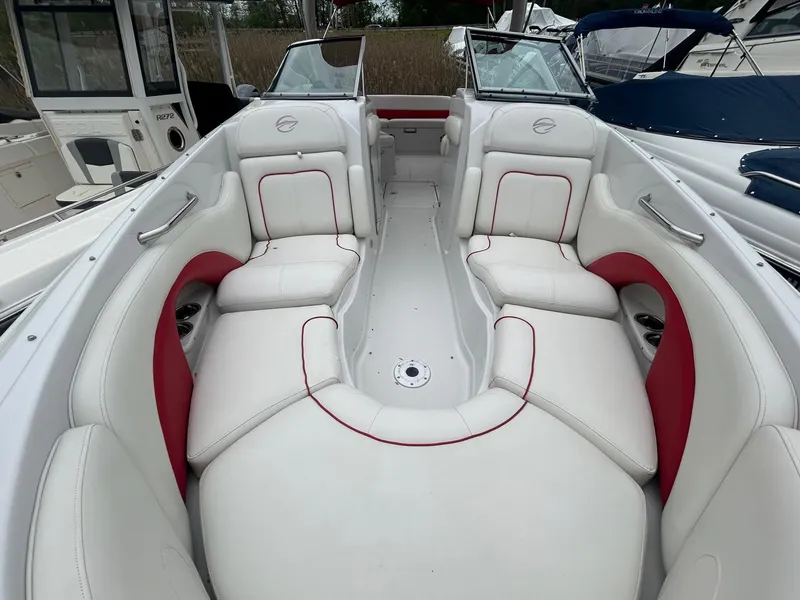 Slide: The Image of 2009 Crownline 300 LS boat interior with white and red seating. - 7