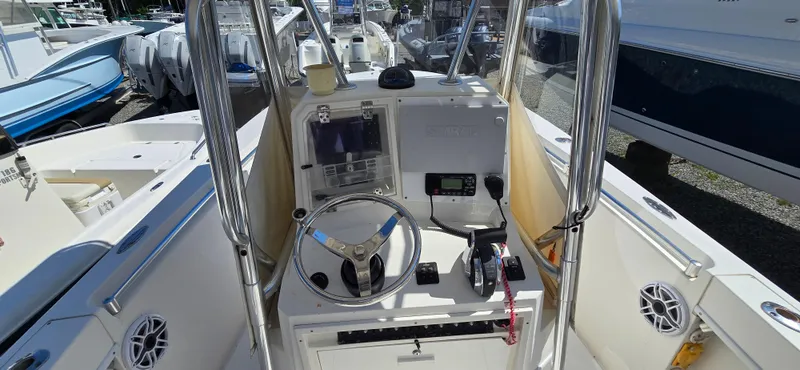 Slide: The Image of 2008 Contender 23 Tournament boat console with steering wheel and navigation equipment. - 12