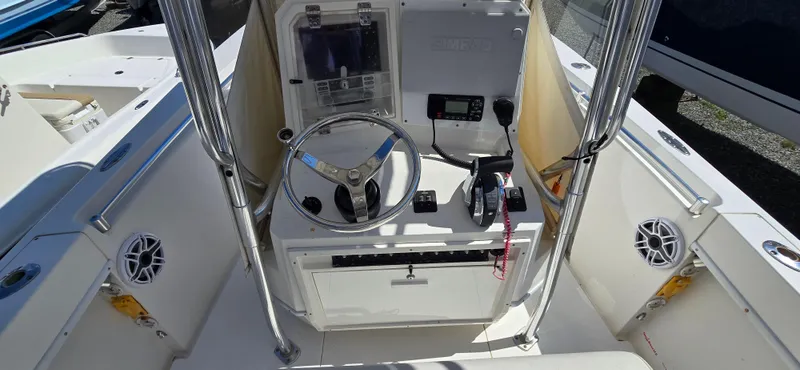 Slide: The Image of 2008 Contender 23 Tournament boat console with steering wheel and navigation equipment. - 2
