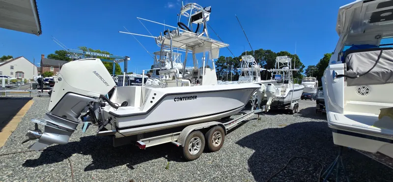 Slide: The Image of 2008 Contender 23 Tournament boat on trailer in marina under clear blue sky. - 22