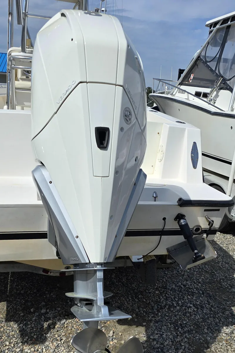 Slide: The Image of 2008 Contender 23 Tournament boat with outboard motor, displayed on gravel surface. - 26
