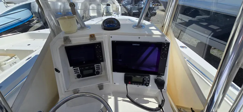 Slide: The Image of 2008 Contender 23 Tournament boat dashboard with navigation equipment and steering wheel. - 3