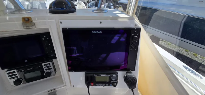 Slide: The Image of 2008 Contender 23 Tournament boat dashboard with Simrad display and radio equipment. - 4