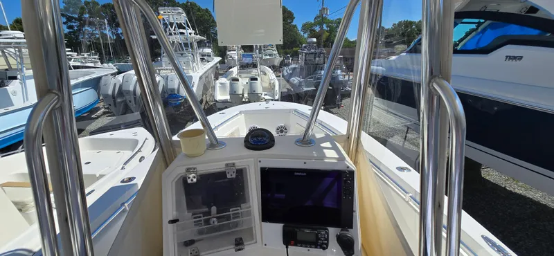 Slide: The Image of 2008 Contender 23 Tournament boat dashboard with navigation equipment, docked among other boats. - 9
