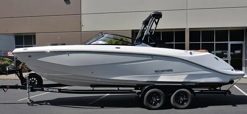 The Image of 2024 Scarab 255 ID boat on a trailer in a parking lot. - 0