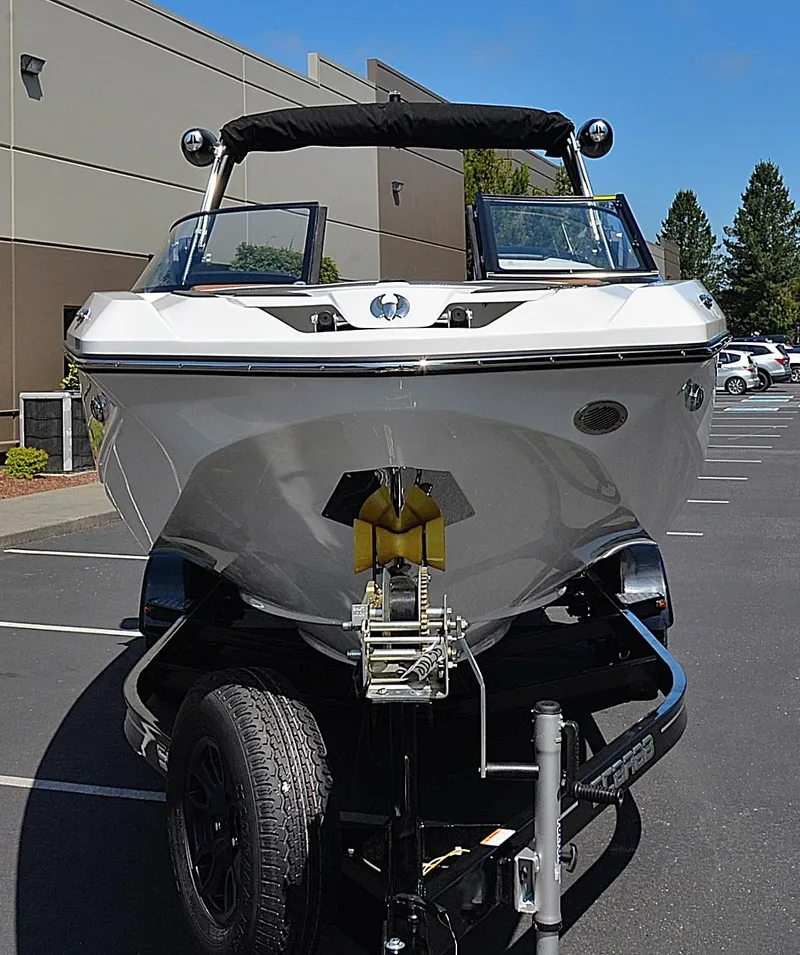 Slide: The Image of 2024 Scarab 255 ID boat on a trailer in a parking lot. - 11