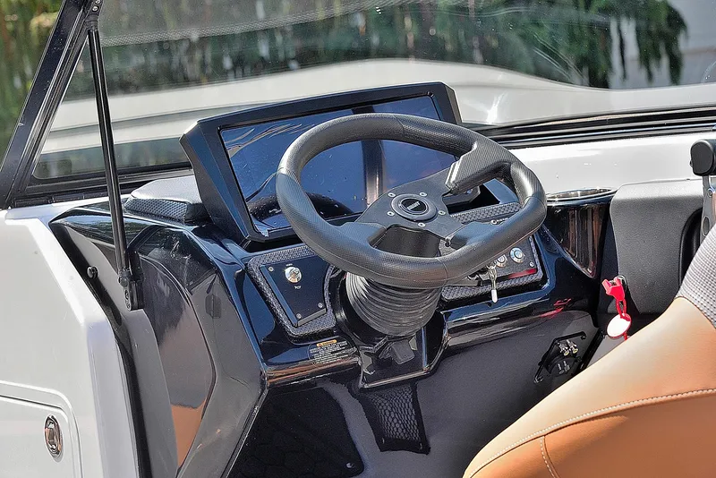 Slide: The Image of 2024 Scarab 255 ID boat dashboard with steering wheel and control panel. - 13
