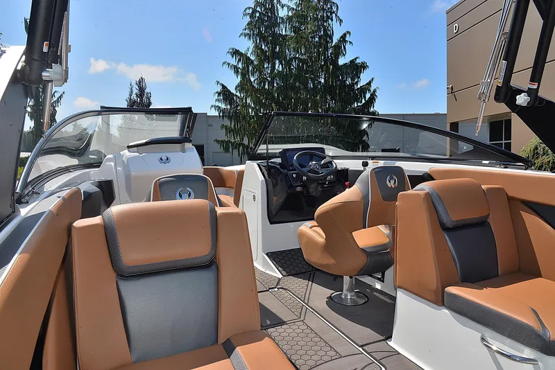 Slide: The Image of 2024 Scarab 255 ID boat interior with tan and gray seating, modern dashboard, and open cockpit. - 14