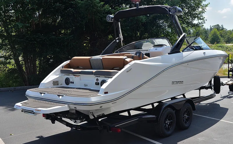 Slide: The Image of 2024 Scarab 255 ID boat on trailer, rear view, parked outdoors. - 4