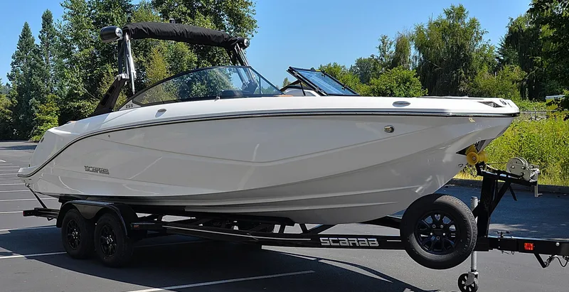 Slide: The Image of 2024 Scarab 255 ID boat on a trailer in a parking lot. - 5
