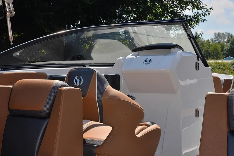 Slide: The Image of 2024 Scarab 255 ID boat interior with tan and black seating. - 6