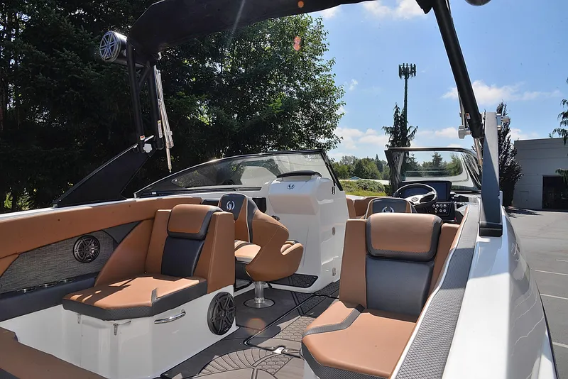 Slide: The Image of 2024 Scarab 255 ID boat interior with tan and black seating, modern dashboard, and open deck. - 7
