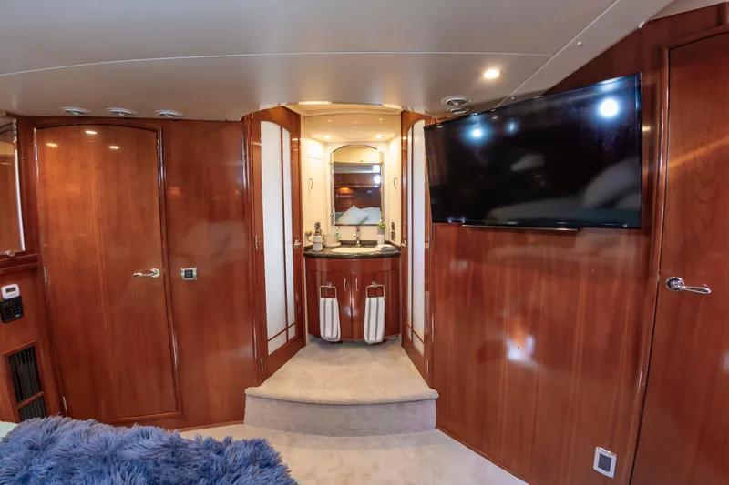 Slide: The Image of Luxurious interior of 2004 Carver 56 Voyager SE yacht with wood paneling and flat-screen TV. - 15