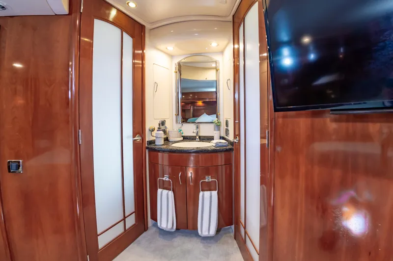 Slide: The Image of Luxurious bathroom in 2004 Carver 56 Voyager SE yacht with wood cabinetry and modern fixtures. - 16