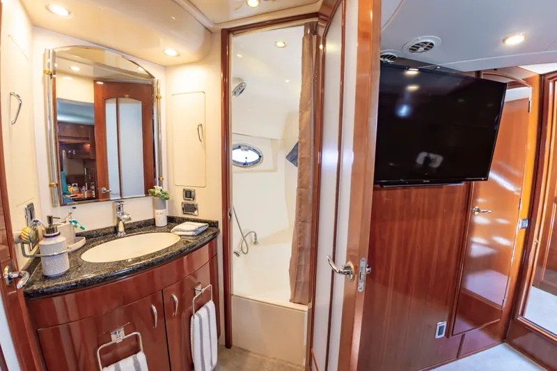 Slide: The Image of Luxurious bathroom in 2004 Carver 56 Voyager SE yacht with vanity, shower, and TV. - 17