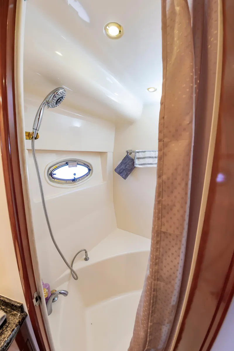 Slide: The Image of Compact shower area in 2004 Carver 56 Voyager SE yacht with porthole and curtain. - 18