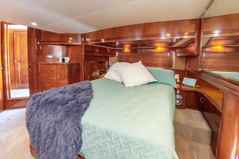 Slide: The Image of Luxurious bedroom in 2004 Carver 56 Voyager SE yacht with wooden cabinetry. - 21