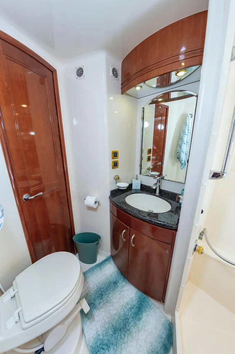 Slide: The Image of 2004 Carver 56 Voyager SE yacht bathroom with wooden cabinetry and modern fixtures. - 22