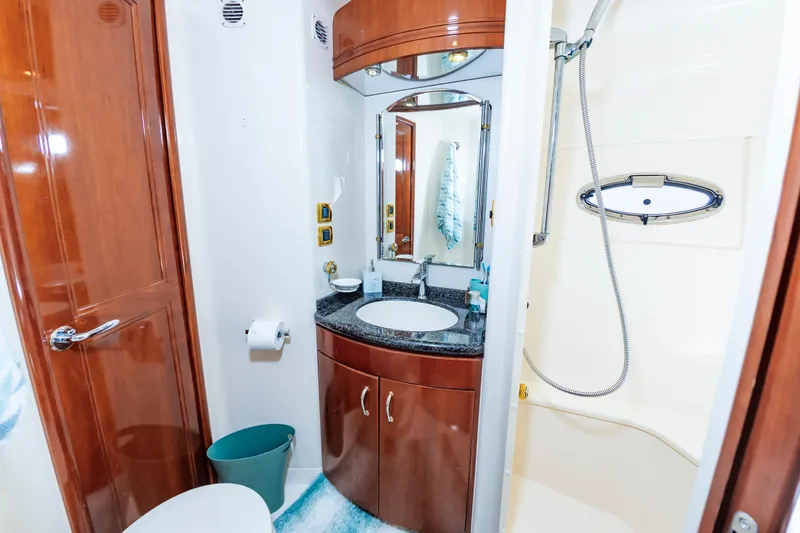 Slide: The Image of 2004 Carver 56 Voyager SE yacht bathroom with wooden cabinetry and modern fixtures. - 23