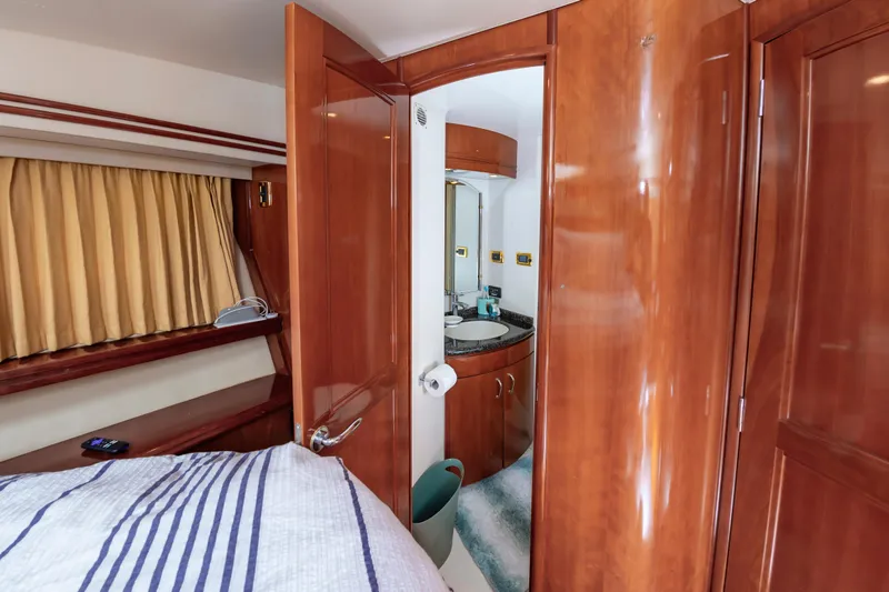 Slide: The Image of Interior of 2004 Carver 56 Voyager SE yacht showing bedroom and bathroom. - 25