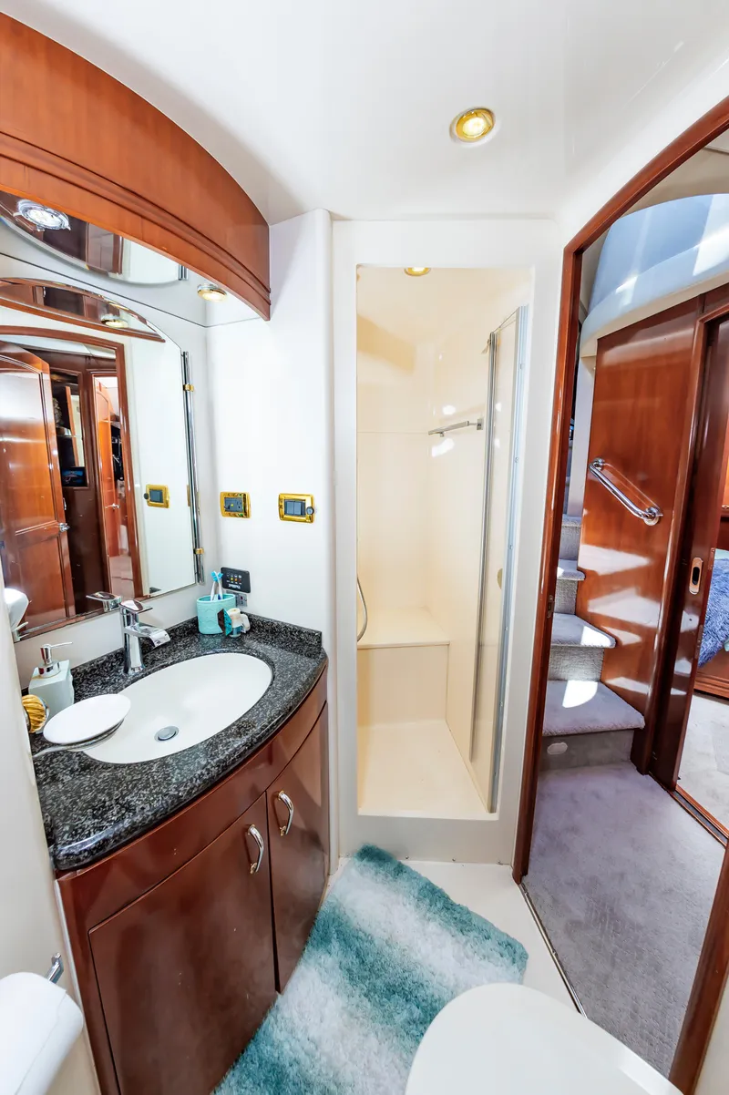 Slide: The Image of Luxurious bathroom in 2004 Carver 56 Voyager SE yacht with granite countertop and shower. - 27
